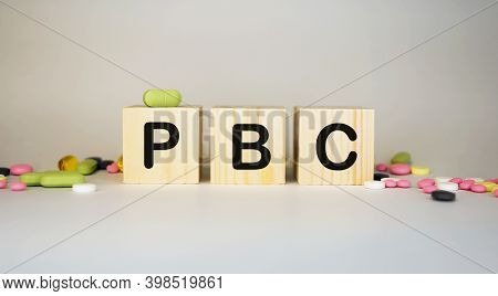 Pbc Primary Biliary Cholangitis - Word From Wooden Blocks With Letters On White Background Surrounde