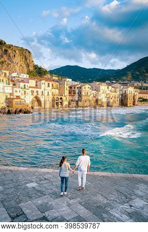 Couple On Vacation Sicily Visiting The Old Town Of Cefalu, Sunset At The Beach Of Cefalu Sicily, Old
