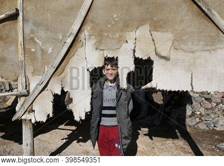 Nigde,turkey-january 15:unidentified Boy Posing With Ripped Carpet.january 15,2017 In Nigde,turkey.