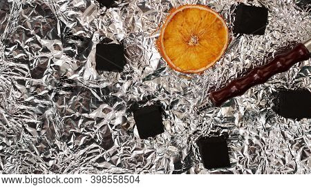 Coals For Hookah On Foil Background With Dry Oranges And Hookah Pipe - Top View