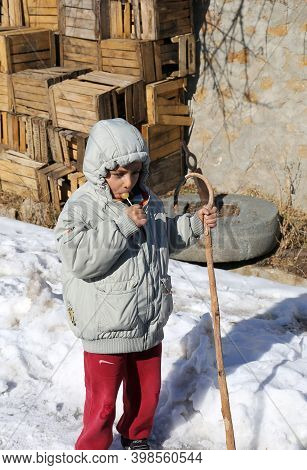Nigde,turkey-january 15:unidentified Boy  With Lolipop Walking With Shepherd Cane In Snow.january 15