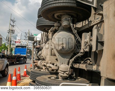 Close-up Of A View Of Under The Truck Carrying A Container Overturned On A Road Under A Bridge Over 