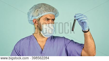 Epidemy Health Danger. Doctor In Respirator Mask. Nurse Look At Test Tube With Blood. Coronavirus Fr
