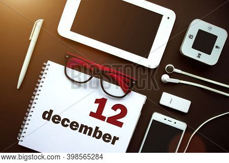 December 12nd. Day 12 Of Month, Calendar Date. Office Workplace With Laptop, Notebook, Office Suppli