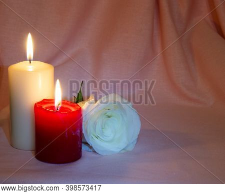 Congratulations On The Holiday. Postcard With Candles And A Rose On A Pink And White Background
