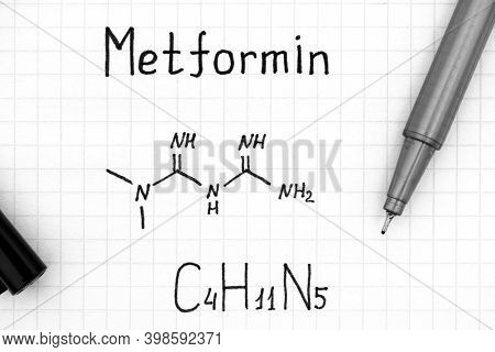 Chemical Formula Of Metformin With Pen. Close-up.
