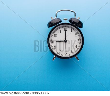 Black Retro Alarm Clock Showing Nine O'clock, Closeup Top View Clipping Path, Isolated On Blue Backg