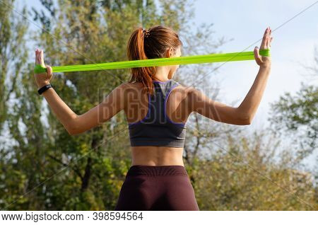 Red-haired Girl Plays Sports On The Playground. Healthy Lifestyle.