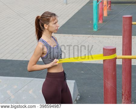 Red-haired Girl Plays Sports On The Playground. Healthy Lifestyle.