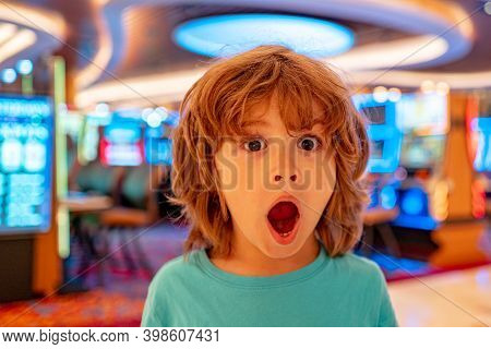 Chikd And Casino Concept. Gambling. Surprise Emotions.