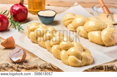 Challah Bread Before Baking. Proofing Sweet Buns Sprinkled With Sesame Seeds On Parchment. Pomegrana