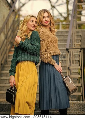 Completing Each Other. Matching Outfits. Women Sisters Outdoors Stairs Background. Vogue Concept. Gi