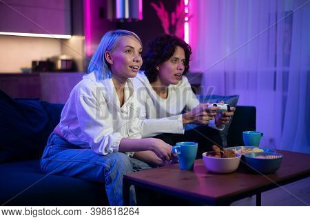 Handsome Young Man Teaching How To Play The Video Games To His Girlfriend, On The Couch, Concept Abo