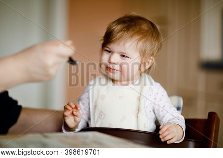 Adorable Baby Girl Eating From Spoon Mashed Vegetables And Puree. Food, Child, Feeding And People Co