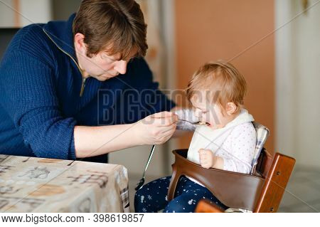 Father Feeding Baby Girl From Spoon Mashed Vegetables And Puree. Food, Child, Feeding And People Con