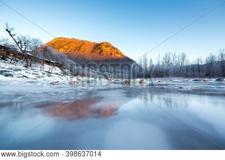 Beautiful Sunny Winter Landscape With Ice River And The Mountain.