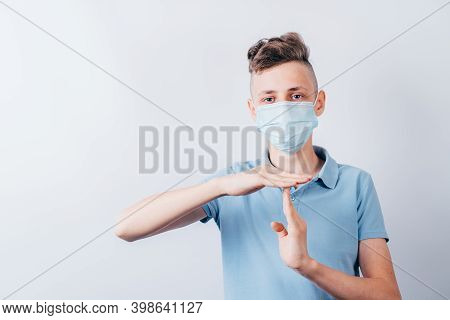 Confident Boy In Medical Mask Showing T Sign With Hands. Quarantine Restrictions, Time Out, End Conc