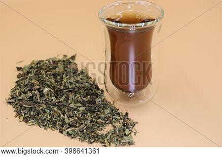 Glass Cup Of Herbal Tea With Folium Plantaginis.