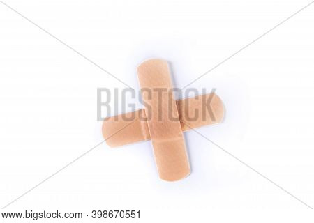 Two Pieces Of Colored Bandage Strips Forming A Plus Medical Sign Top Down View