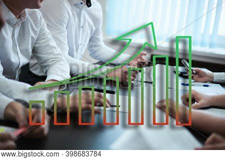 Young People Sitting Behind A Crowd And With An Ascending Schedule. The Concept Of The Banking Syste