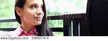 Portrait Of Brunette Woman Sitting On Summer Veranda And Dreamily Looking Into Distance. Positive Af