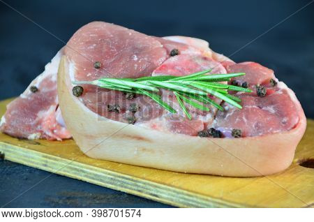 Pieces Of Raw Pork Steaks, With Ingredients For Cooking, Served On Woodenboard. Concept Of Food Prep