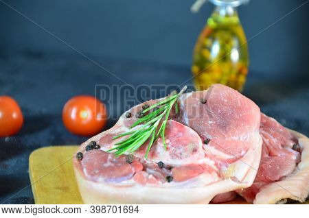 Pieces Of Raw Pork Steaks, With Ingredients For Cooking, Served On Woodenboard. Concept Of Food Prep