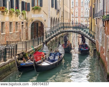 Venice, Veneto, Italy - November 24, 2016: Tourists Enjoy A Lovely Gondola Ride On The Rio De L'albo