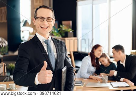 Confident Adult Man In Suit Stands In Front Of Office Of Family Lawyer And Thumb Up.