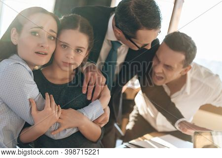 Family Lawyer Is Holding Back Invasive Adult Man Who Is Trying To Hit Restless Wife With Daughter.