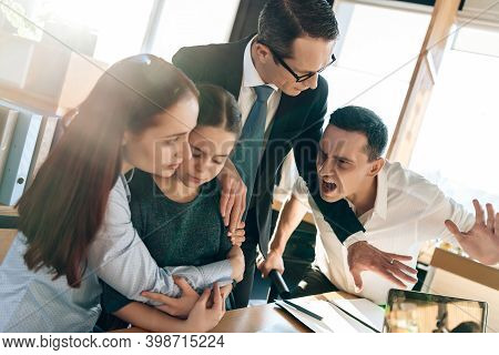 Family Lawyer Is Holding Back Aggressive Adult Man Who Is Trying To Hit Young Wife With Daughter.