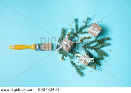 Creative Composition Christmas And New Year. Paint Brush With Christmas Fir And Ornaments On A Red B