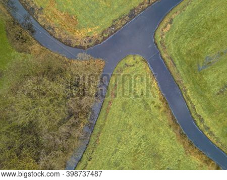 Top Down View Of Intersection Of Rivers In Winter In Lowlands Of Friesland In The Netherlands