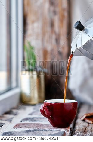 Steaming Coffee Over Wooden Surface And Black Background