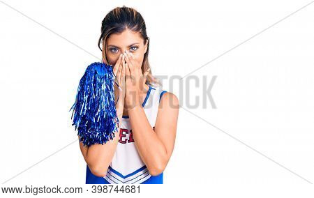 Young beautiful woman wearing cheerleader uniform laughing and embarrassed giggle covering mouth with hands, gossip and scandal concept 