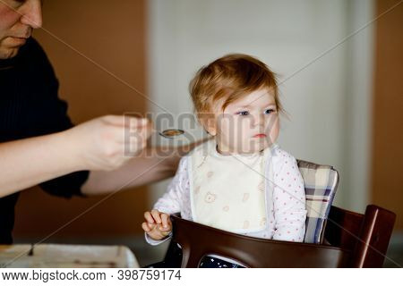 Father Feeding Baby Girl From Spoon Mashed Vegetables And Puree. Food, Child, Feeding And People Con