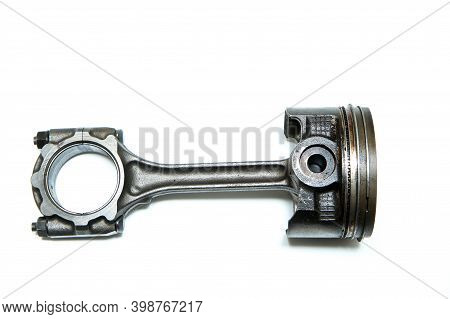 The Used And Dirty Piston With The Connecting Rod From The Sport Engine Isolated In A White Backgrou