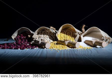 Studio Lighting. Retro Style Wooden Background. There Are Cereals On It. Red Beans, Millet, Pearl Ba