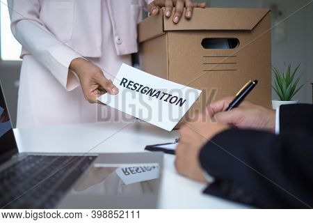 The Business Woman Has A Brown Cardboard Box Next To Her Body And Sends A Letter Of Resignation To T