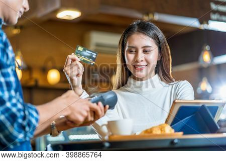 Asian Customer Man Paying With Credit Card Via Contactless Nfs Technology To Asian Barista Of Small 