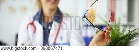 Doctors With Tablet And Glasses In Hands Are Sitting At Table At Meeting In Clinic Closeup. Remote C
