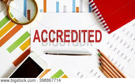 Word Writing Text Accredited On Notepad. Business Concept With Office Tools On Chart Background