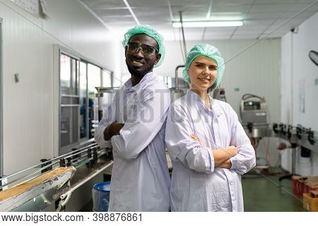 A Quality Supervisor Or A Food Technician Is Inside The Juice Chamber. Employees Are Happy To Work W