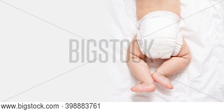 Cute Caucasian Infant Baby In White Nappy On Light Grey Blanket. Top View. Banner Format. Copy Space