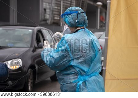 A Medical Worker Wearing Special Suit To Protect Against Coronavirus, Conduct A 