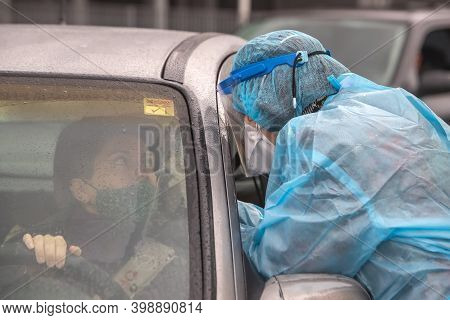 A Medical Worker Wearing Special Suit To Protect Against Coronavirus, Conduct A 