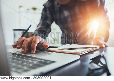 Close Up Hand Of Business Man Searching On Laptop And Using Computer To Find Information To Write On