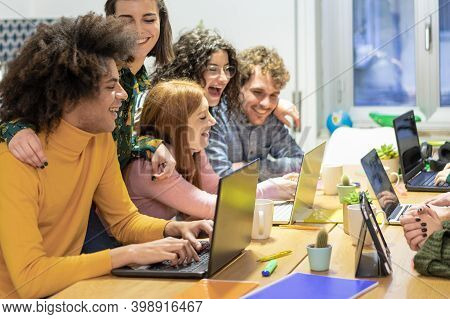 Young Teamwork Using Computer In The Apartment. Millennial People Working Together At New Project. Y