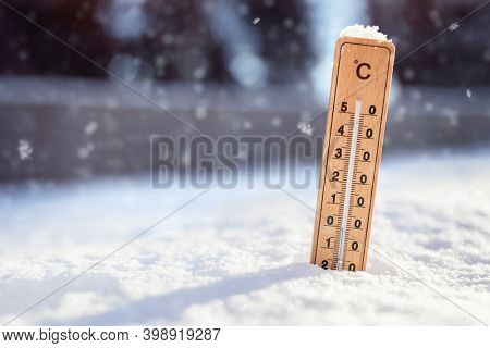 Thermometer in the snow background with sub zero minus temperature concept for winter