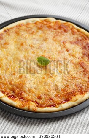 Homemade Neopolitan Pizza With Cheese And Basil, Low Angle View. Close-up.